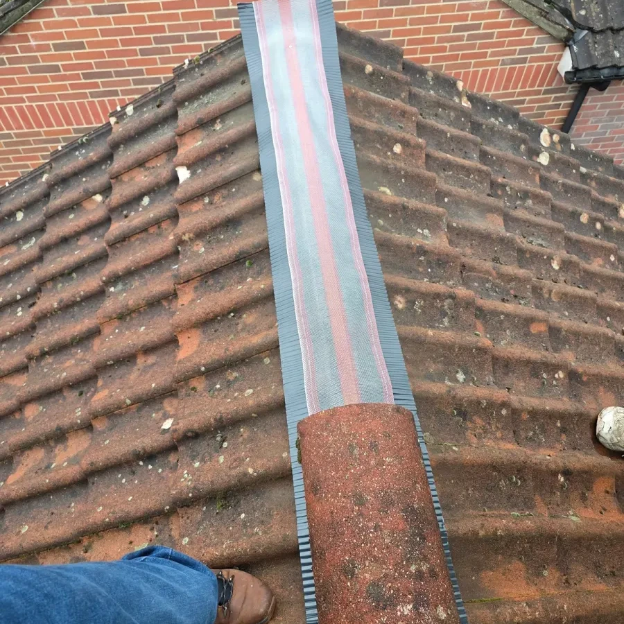 Close view of a metal strip held against a brick corner