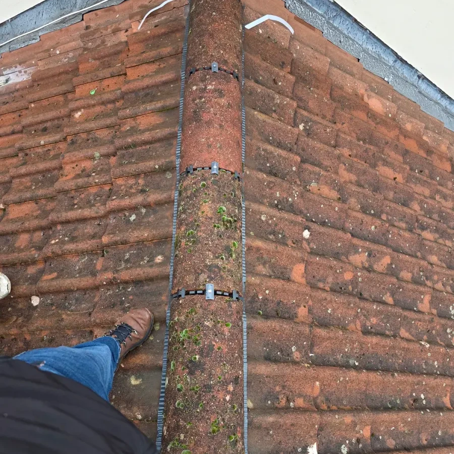Brick corner with repair work visible below the roof edge