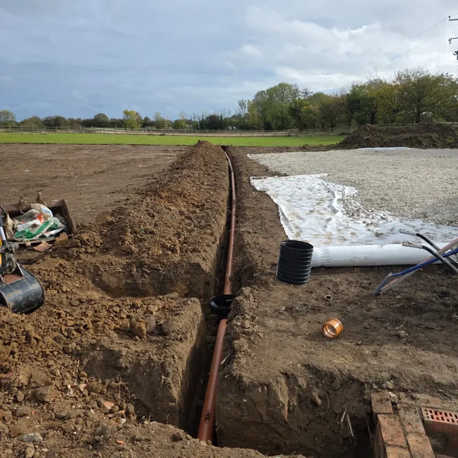 Trench and brick edging beside a prepared gravel base