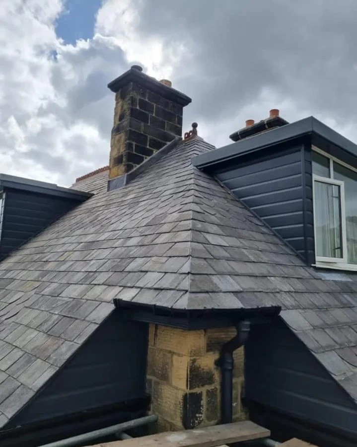 Slate roof around dormer windows and a chimney