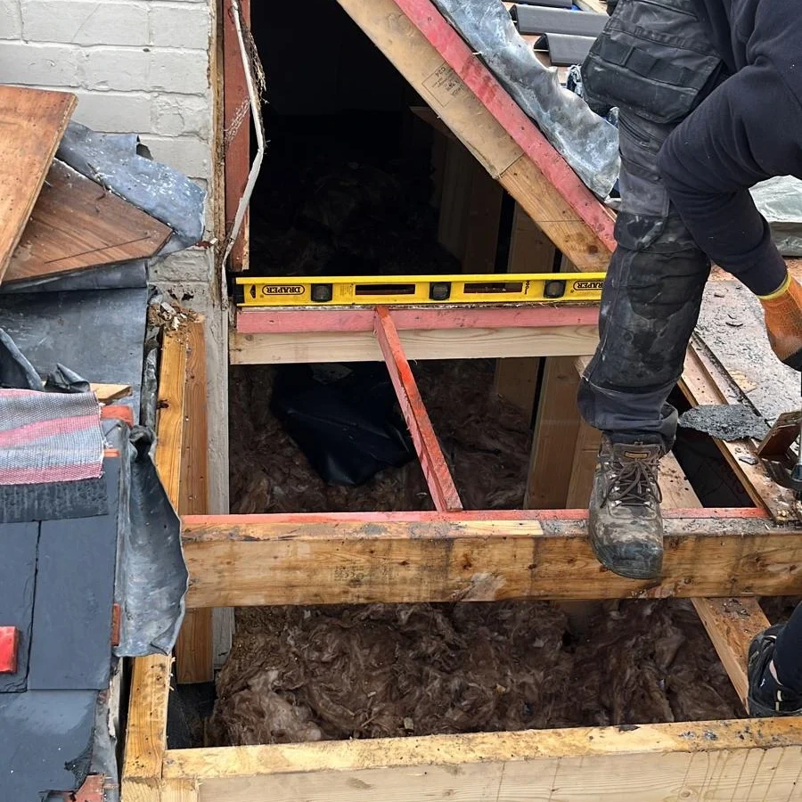 Roof timbers exposed beside a gable opening