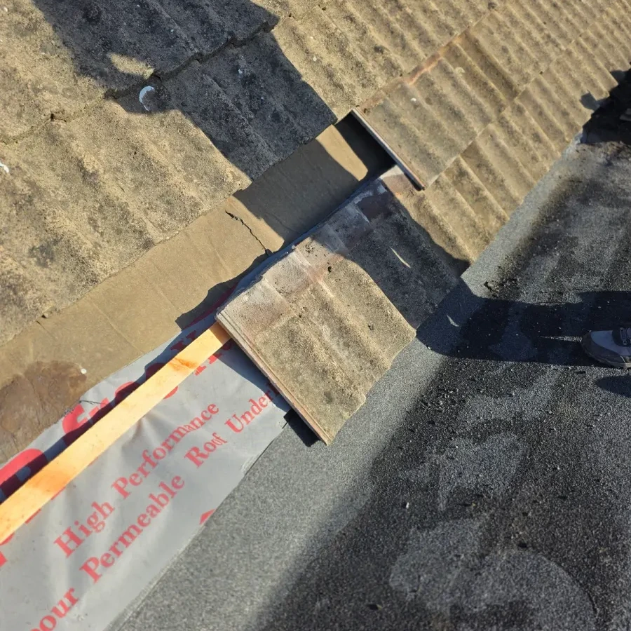 Roof covering lifted to expose the underlay and timber edge