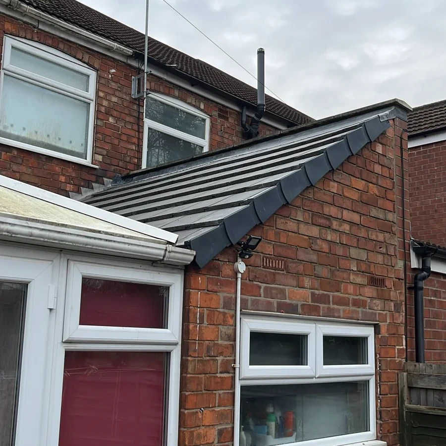 Slate roof above a brick entrance extension