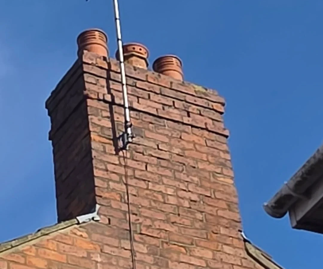 Brick chimney stack and pots viewed from below