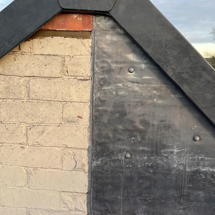 Gable end with slate edge and flashing detail