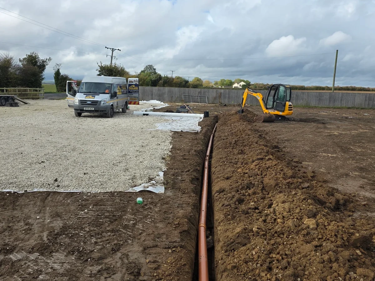 Long run of brick edging beside prepared ground