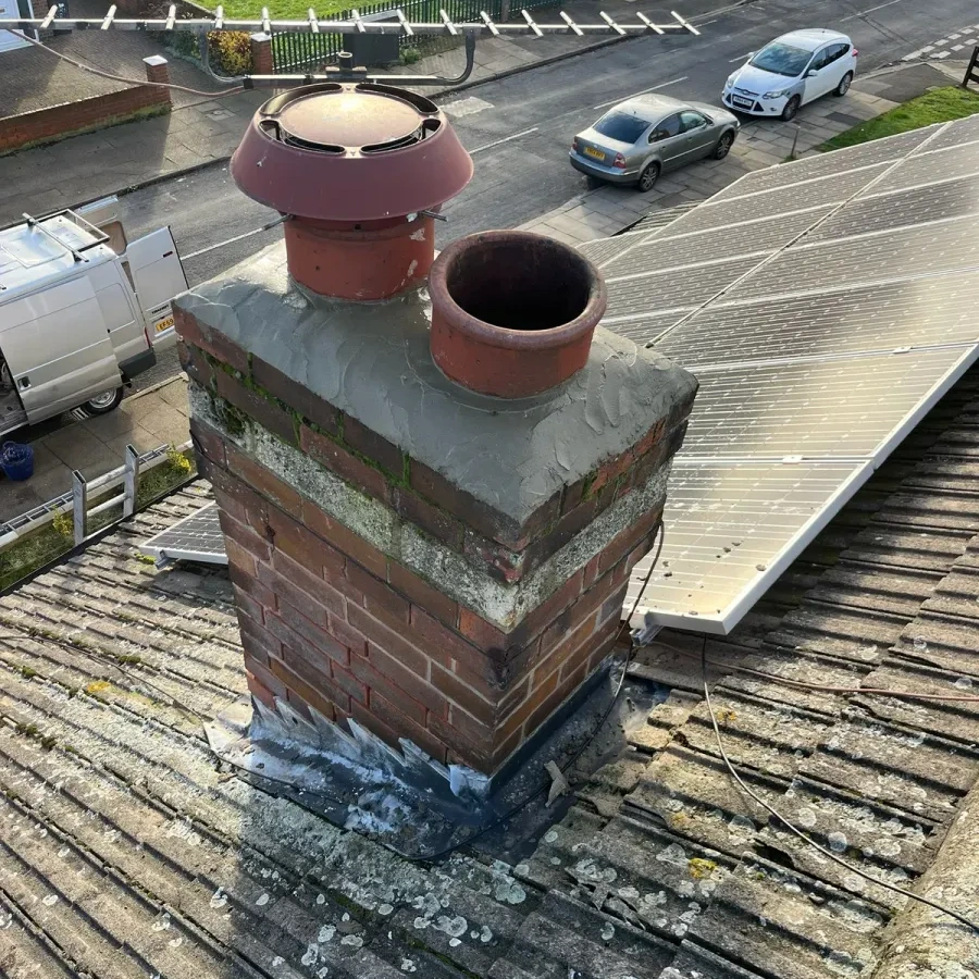 Brick chimney stack with pots and roof flashing