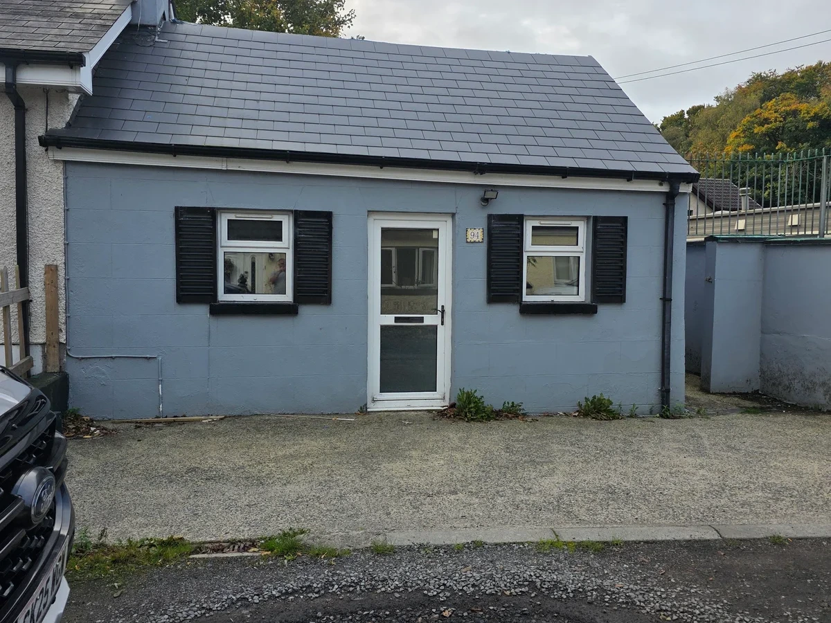 Slate roof on a rendered single storey building