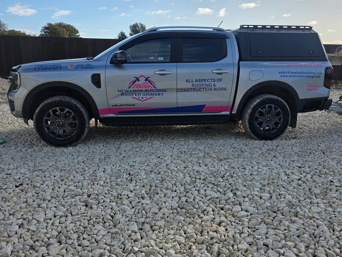Branded New Look work vehicle on a gravel area
